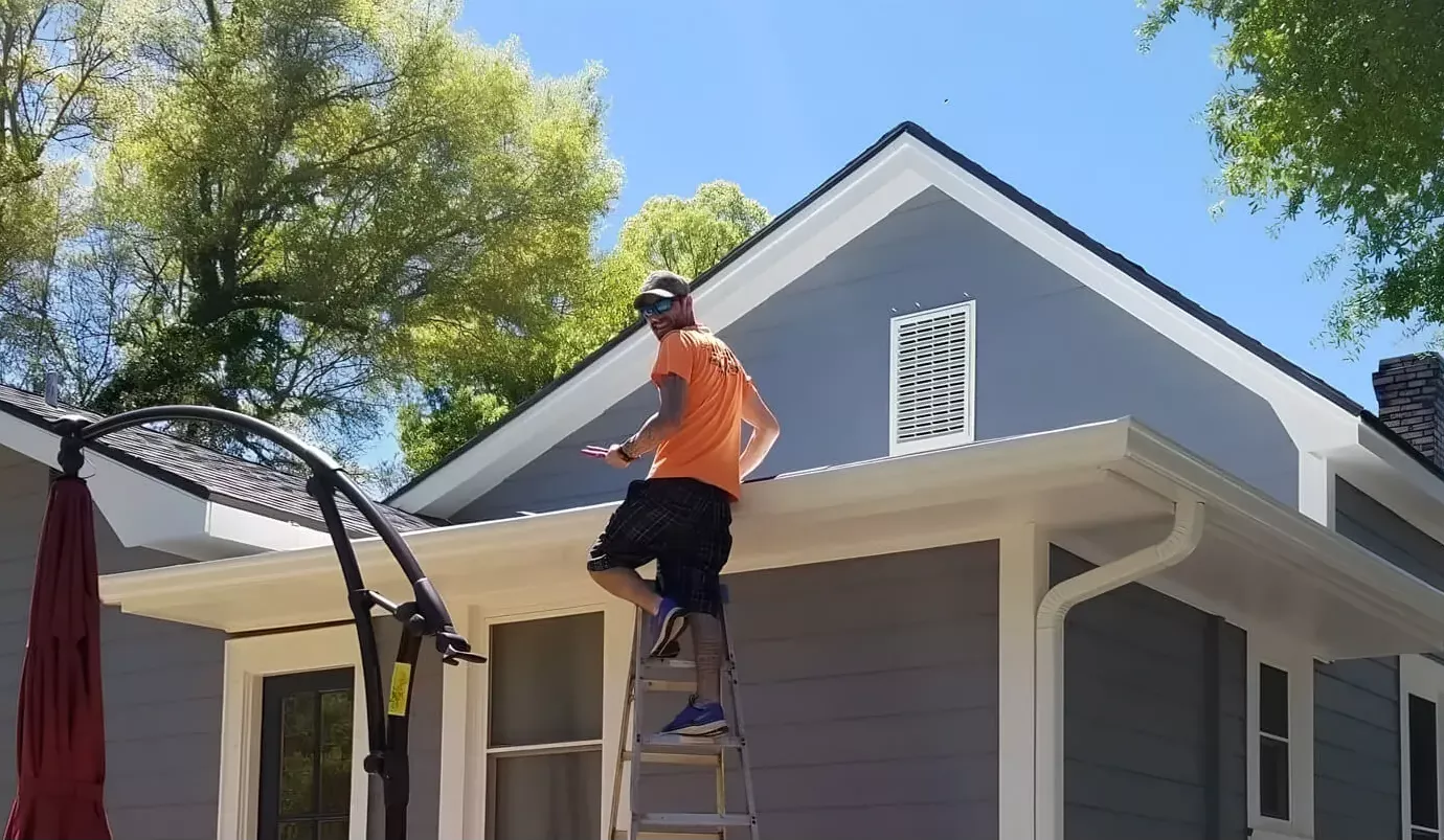 A man standing on top of a ladder.